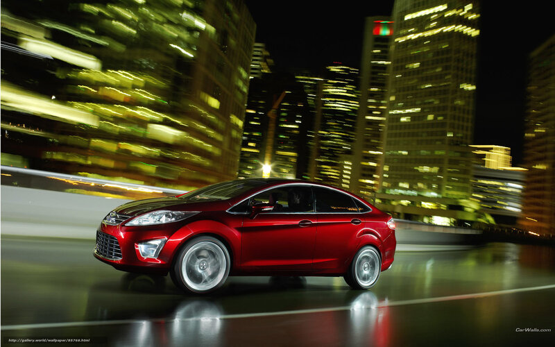 Red car in city at night