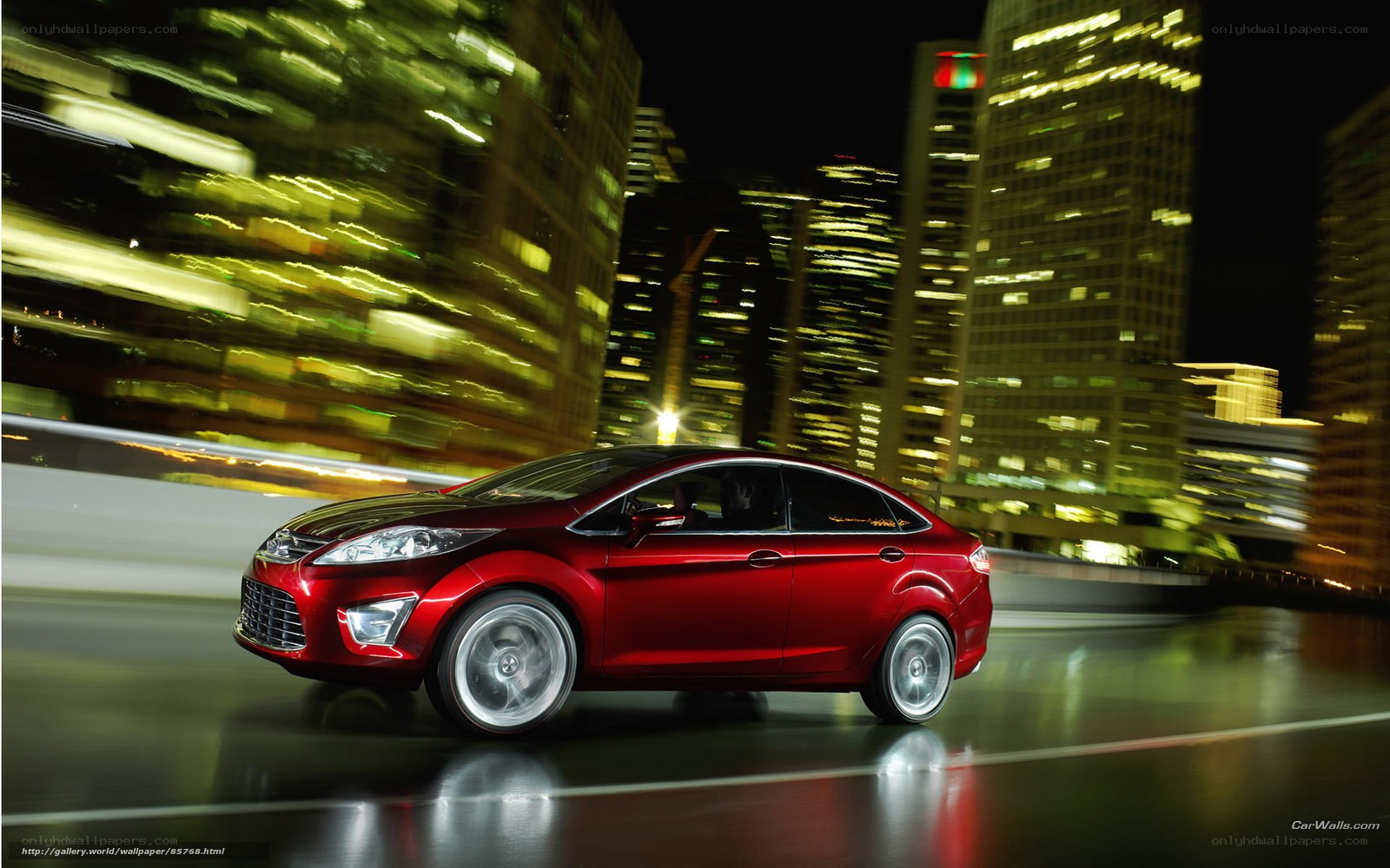 Red car in city at night