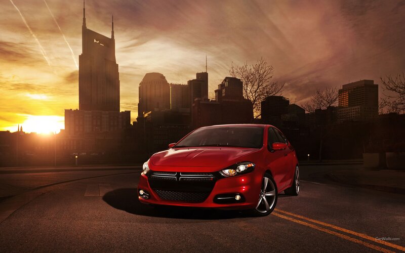 Red car in city at sunset