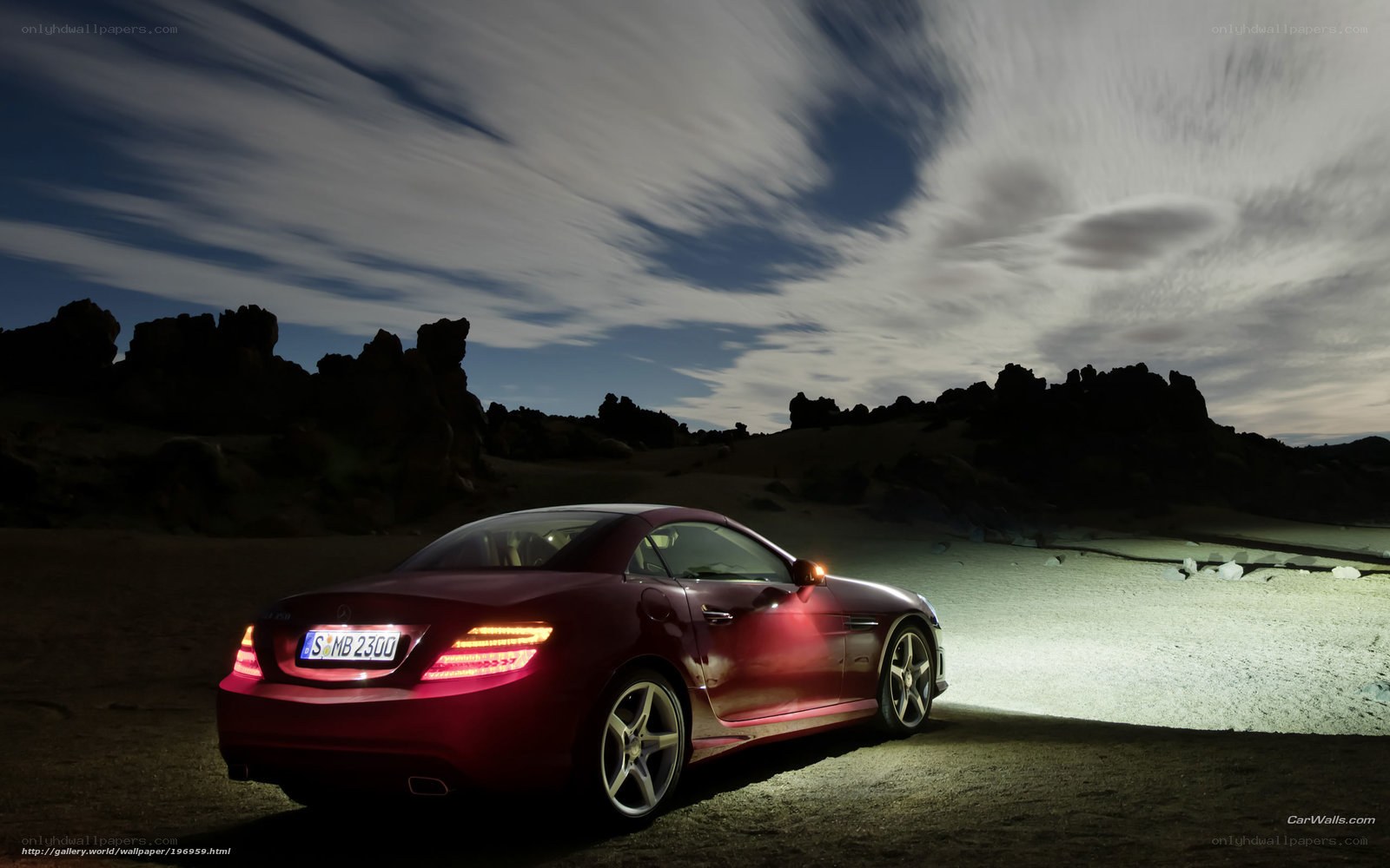 Red car in desert landscape