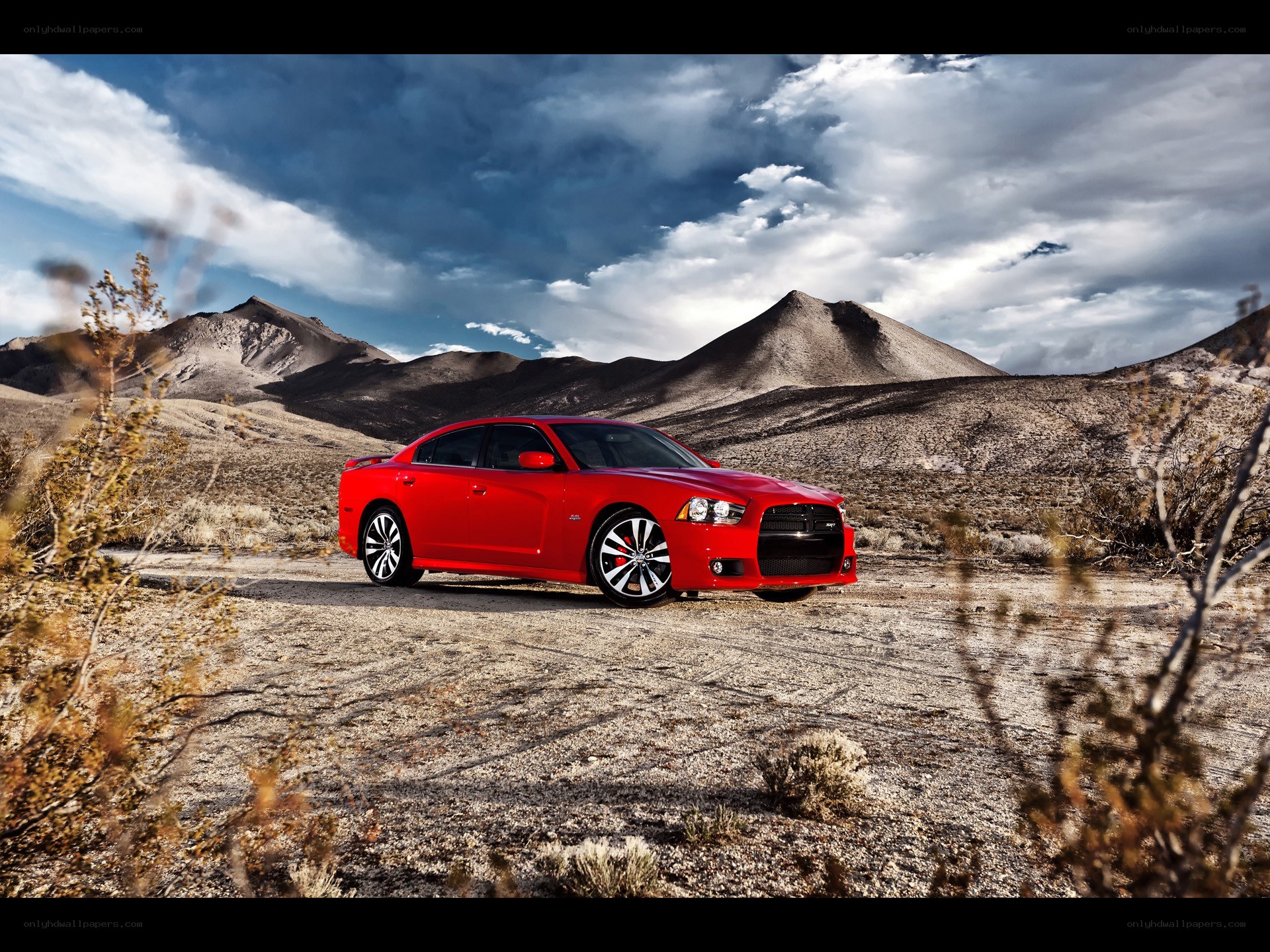 Red car in desert landscape