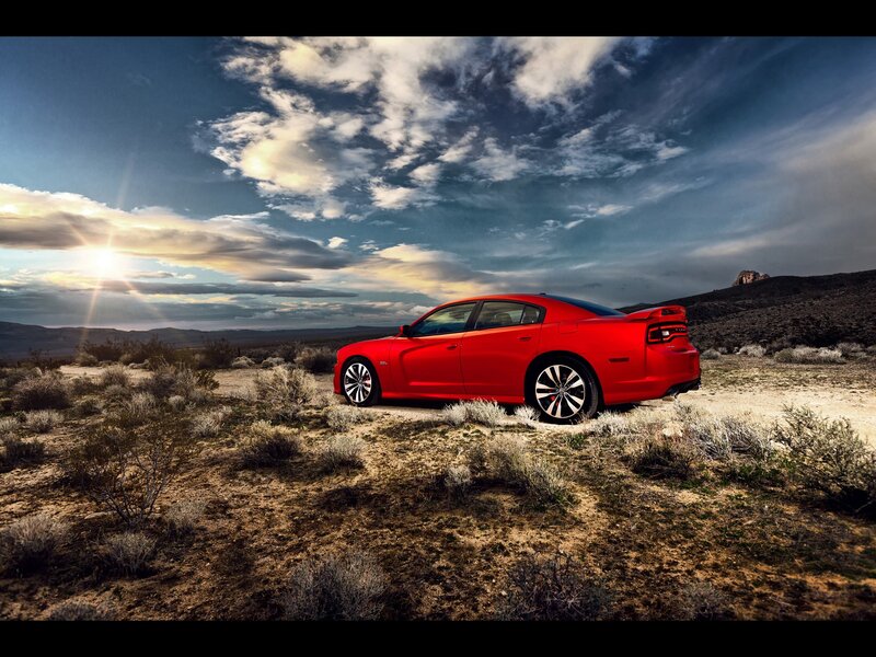 Red car in desert landscape