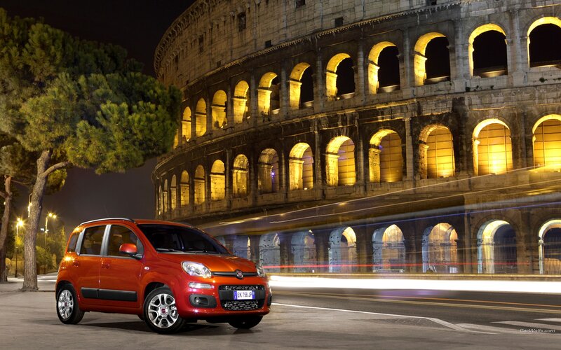 Red car in front of Colosseum