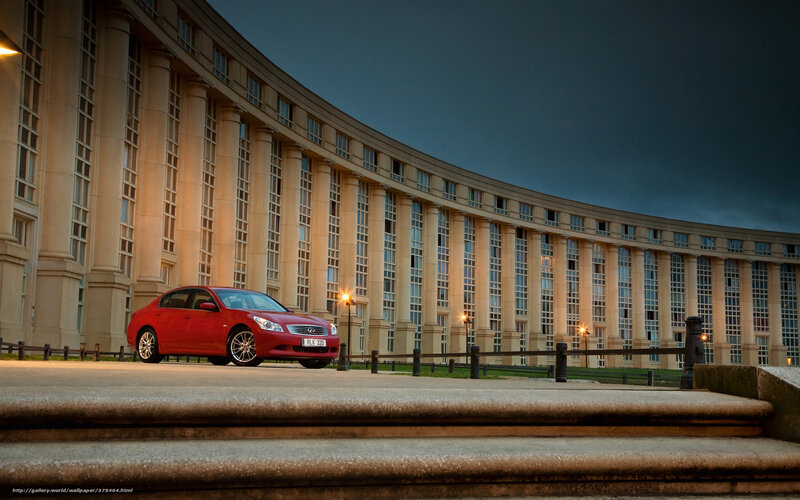 Red car in front of curved building