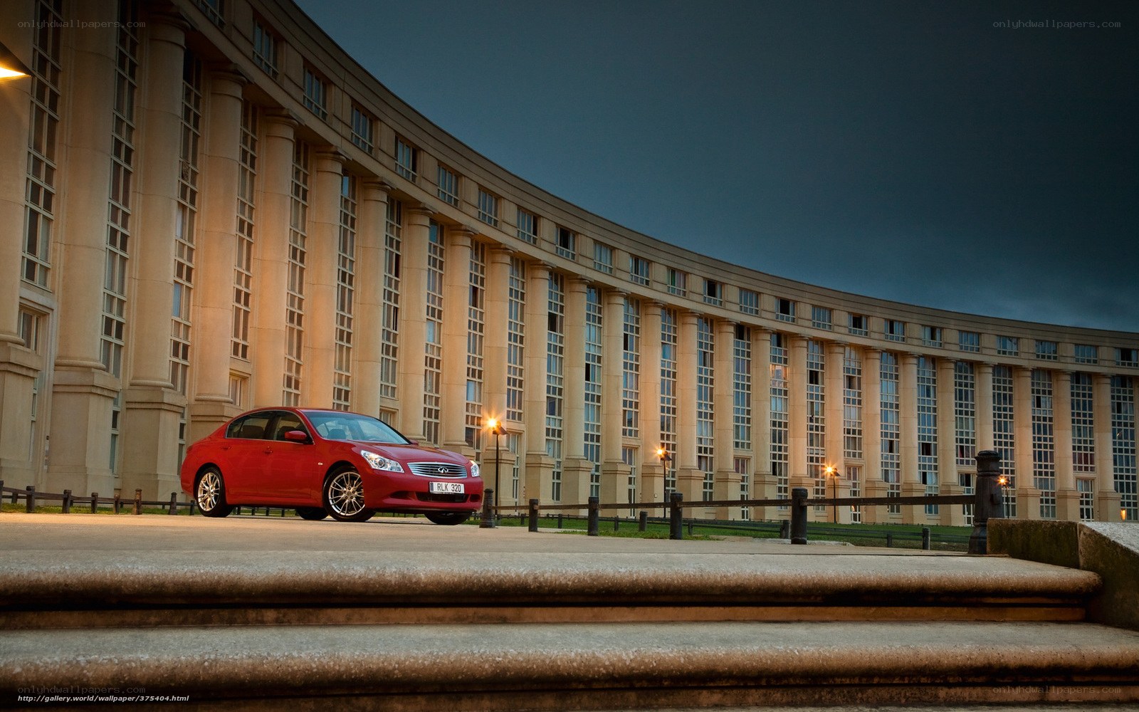 Red car in front of curved building