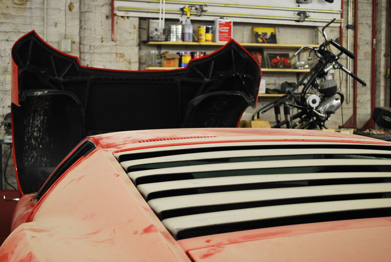 Red car in garage workshop