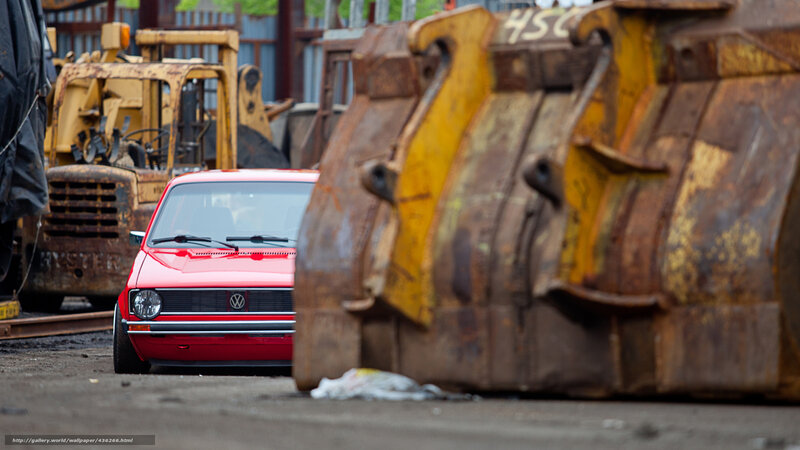 Red car in junkyard