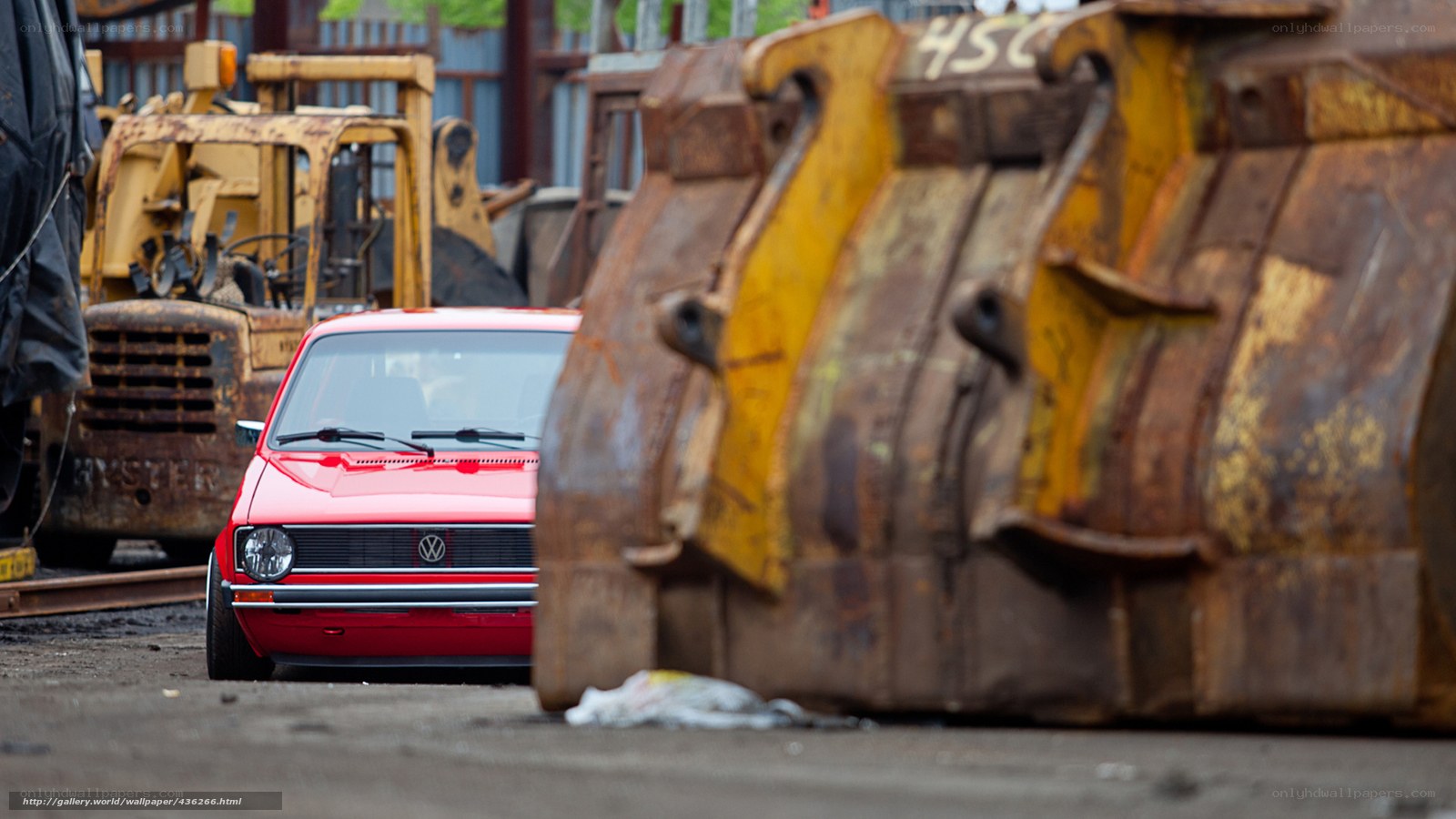 Red car in junkyard