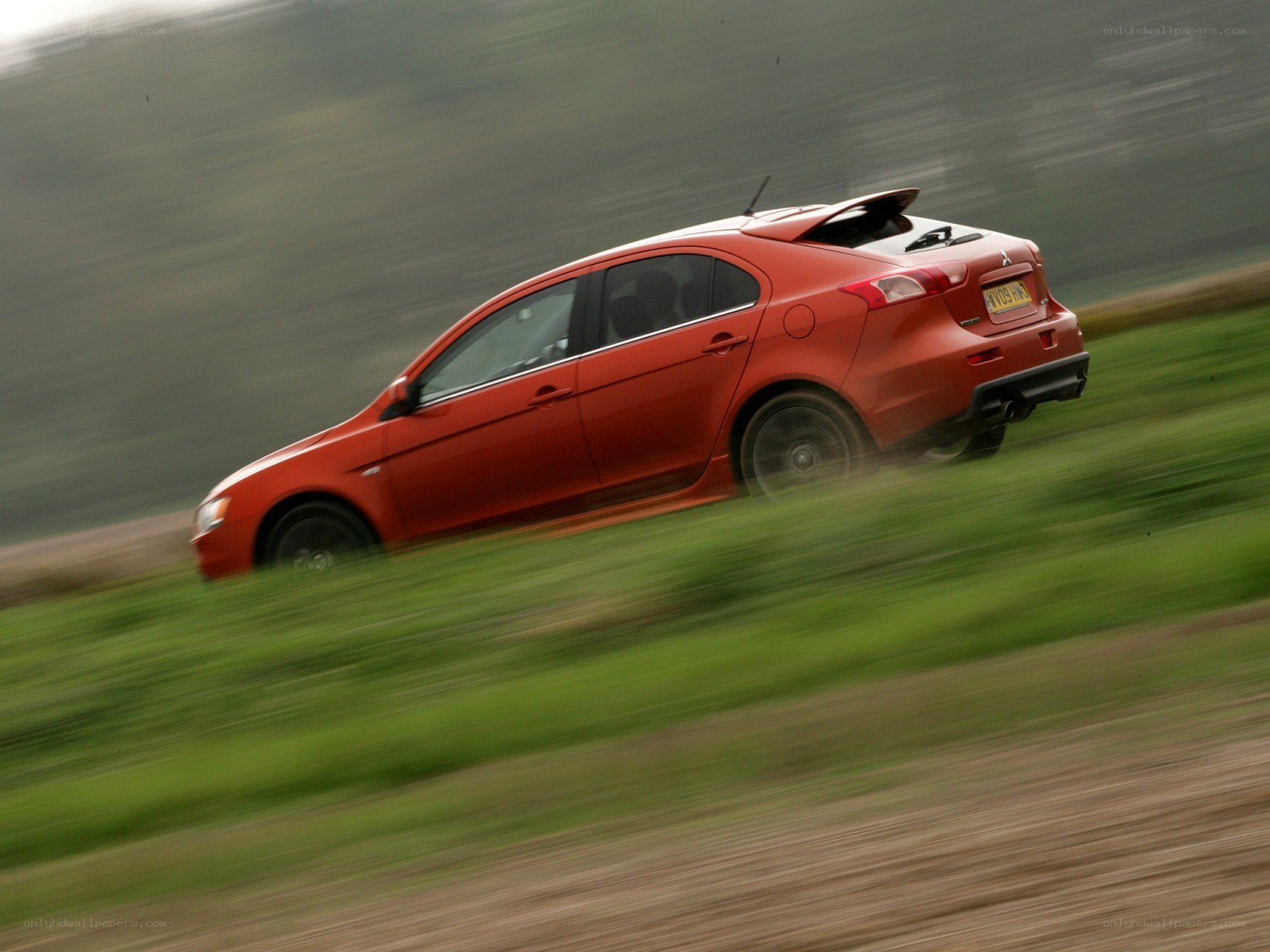 Red car in motion on a road