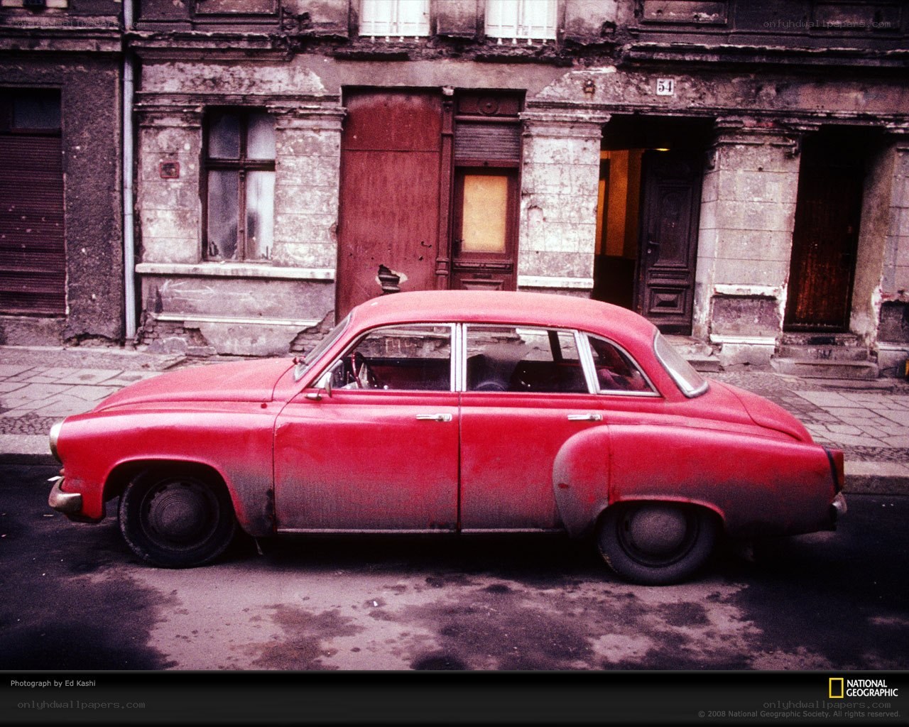 Red car in old city