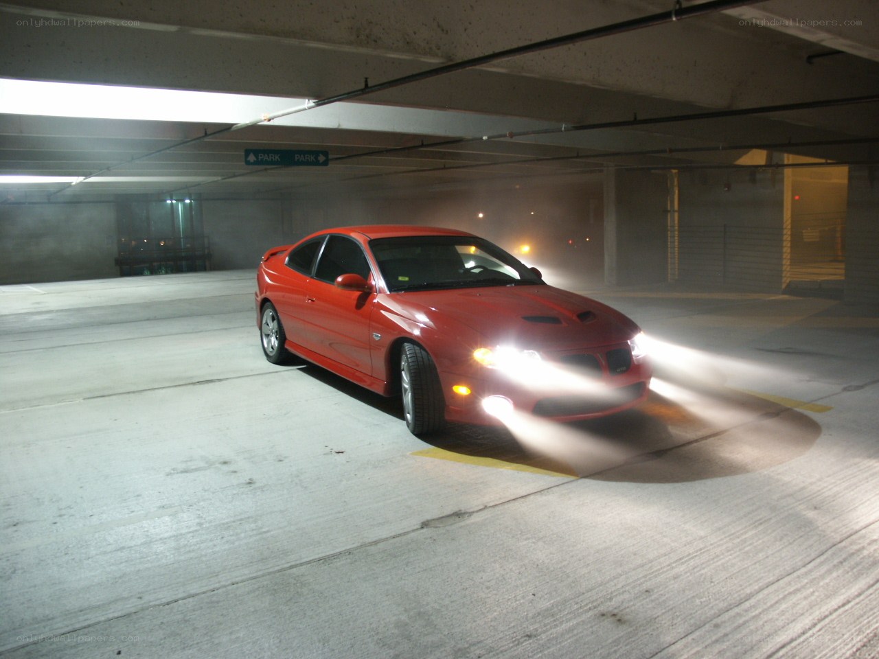 Red car in parking garage
