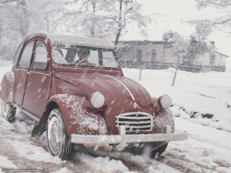 Red car in snowy landscape
