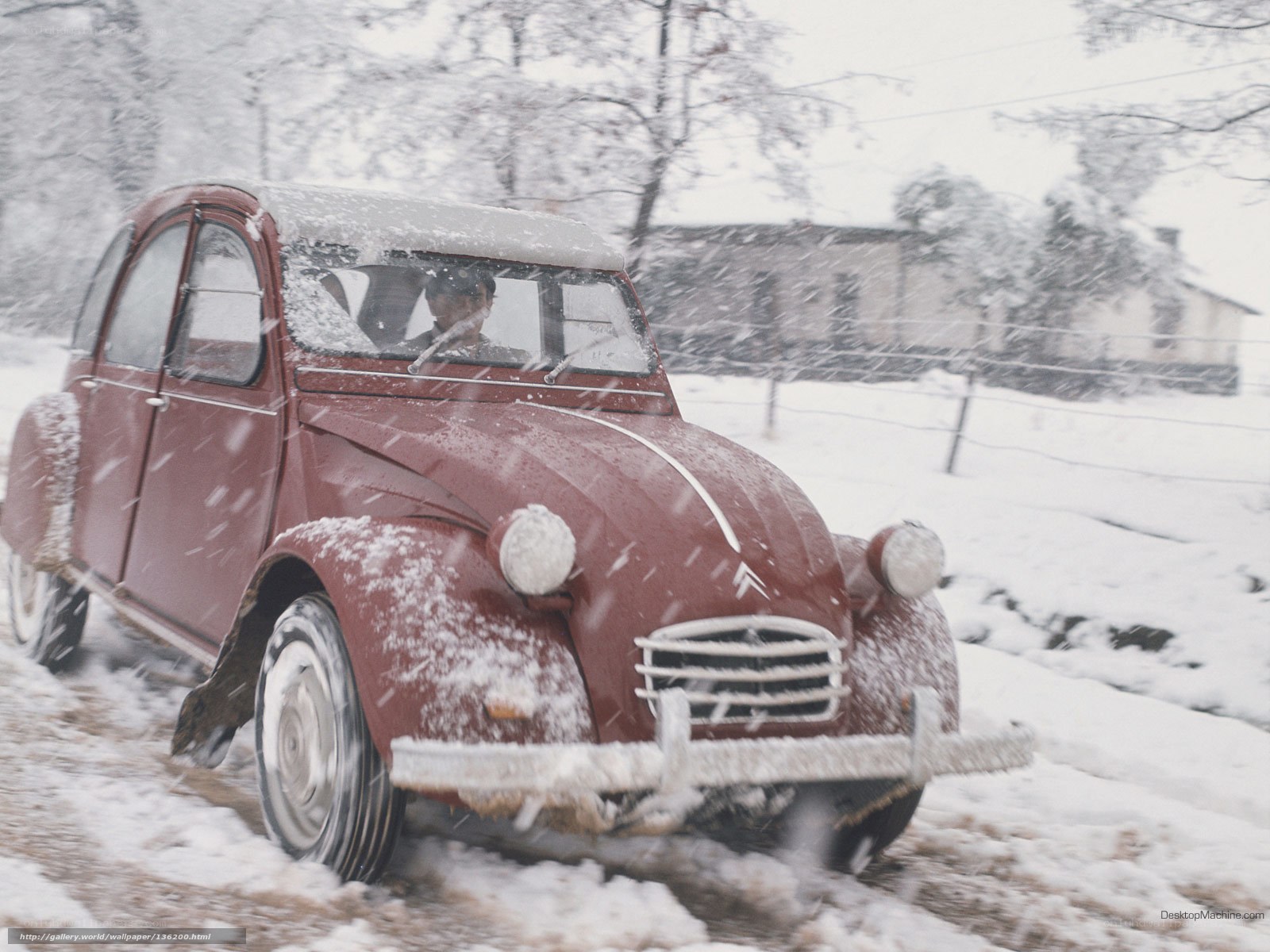 Red car in snowy landscape