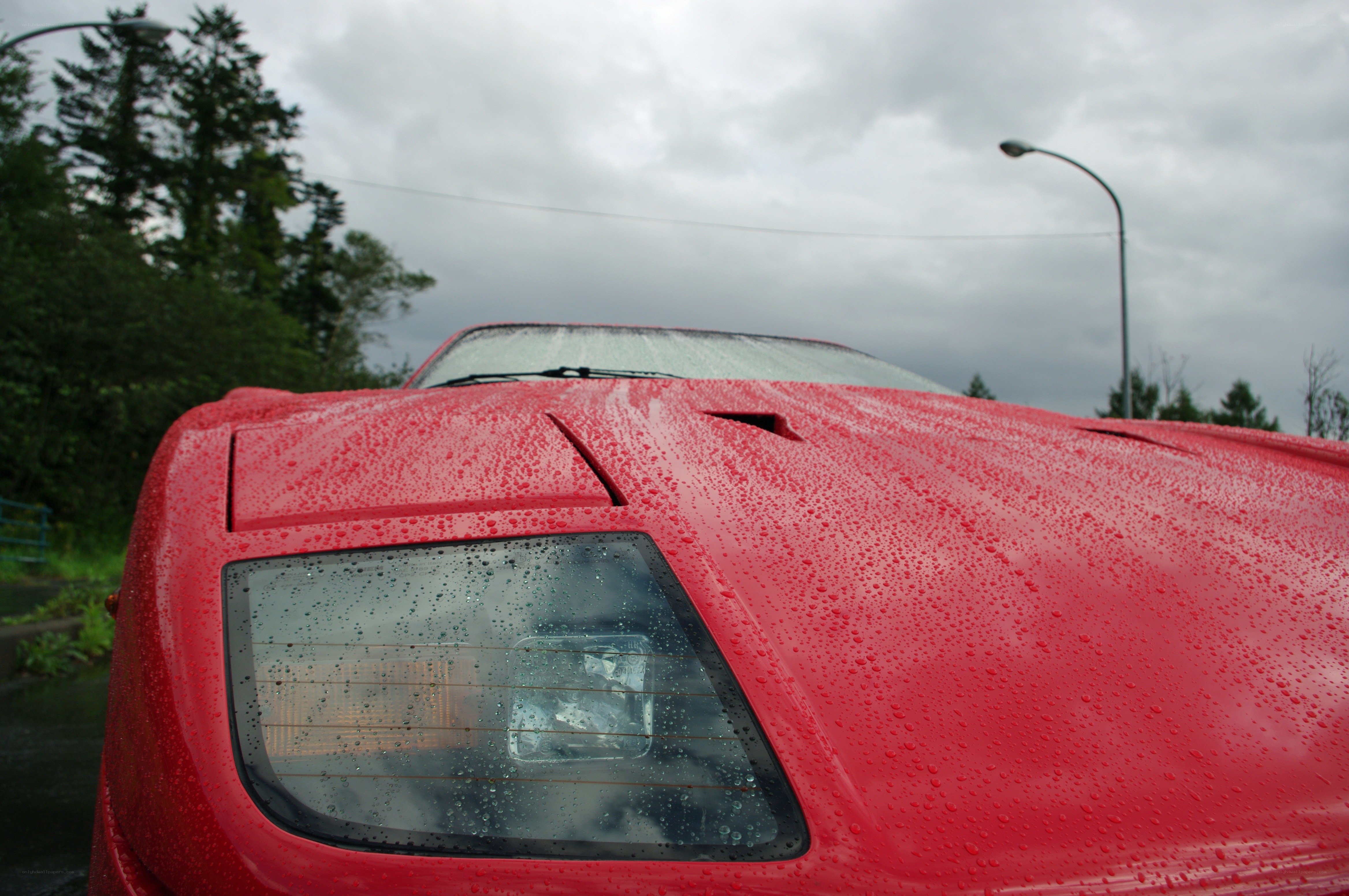 red car in the rain