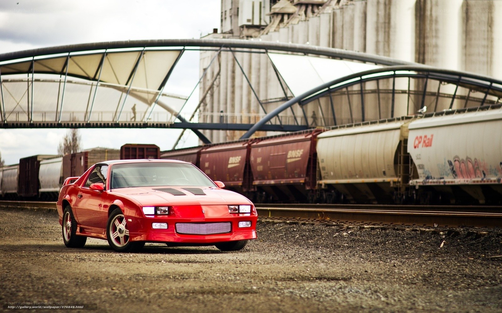 Red car near train tracks