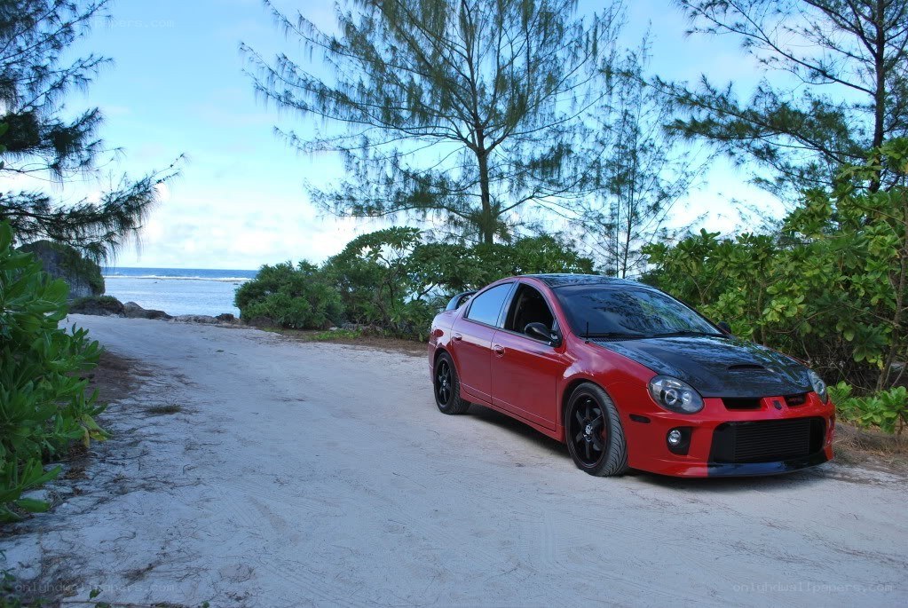 Red car on a beach road
