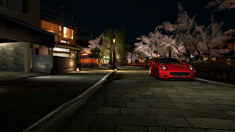 Red car on a cherry blossom street