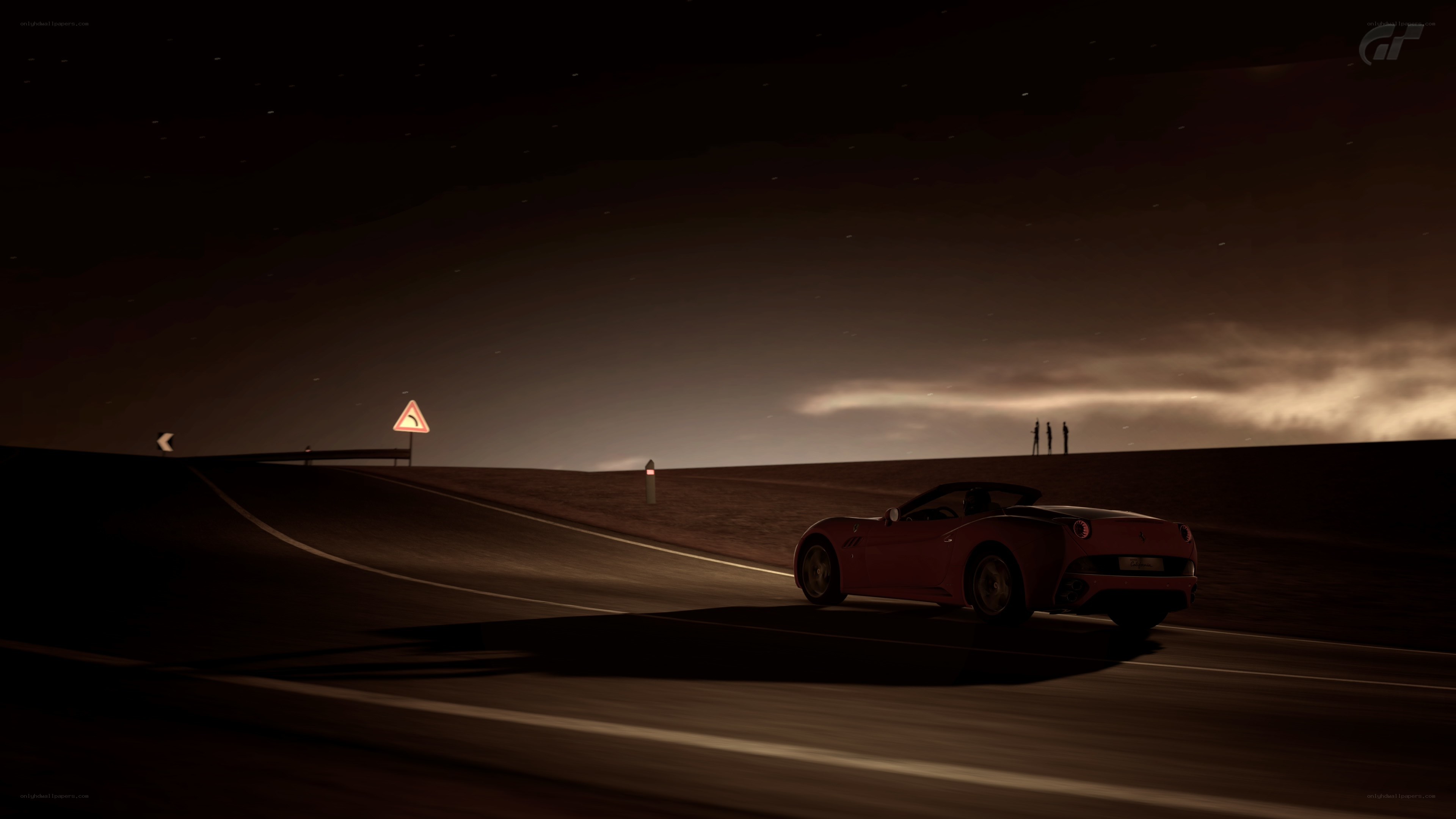 Red car on a dark road