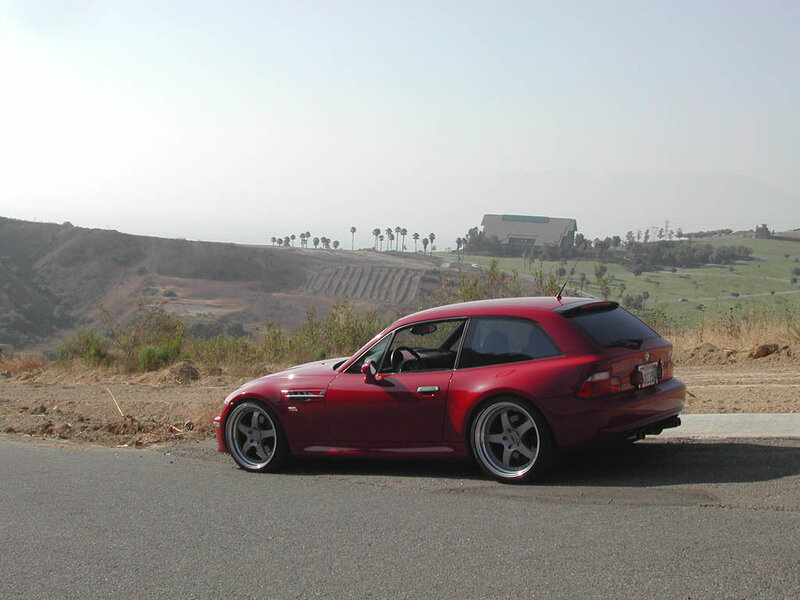 red car on a hillside road