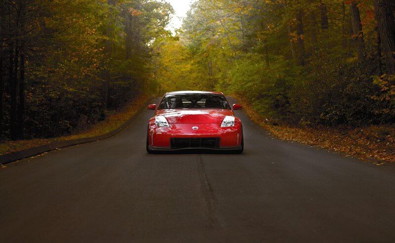 Red car on autumn road