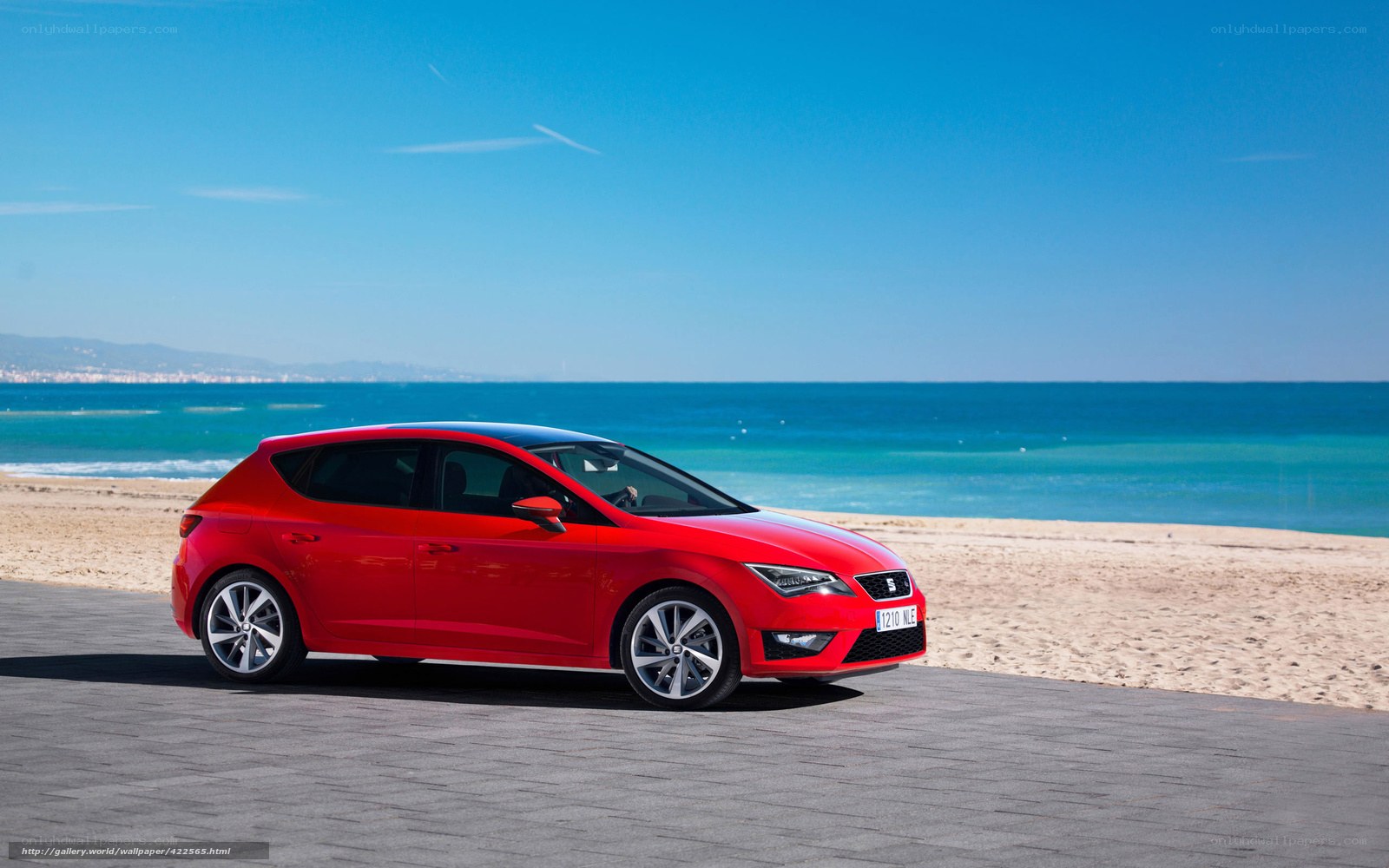 Red car on beach promenade