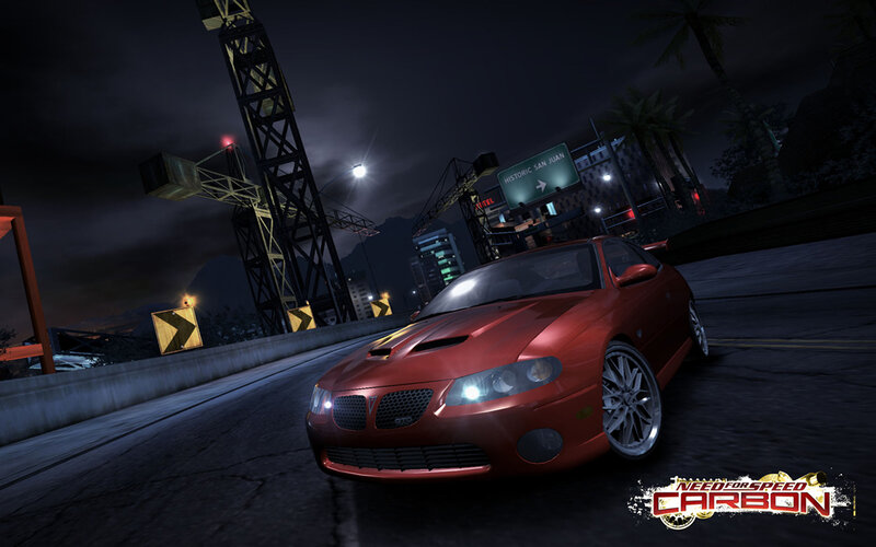 Red car on city street at night