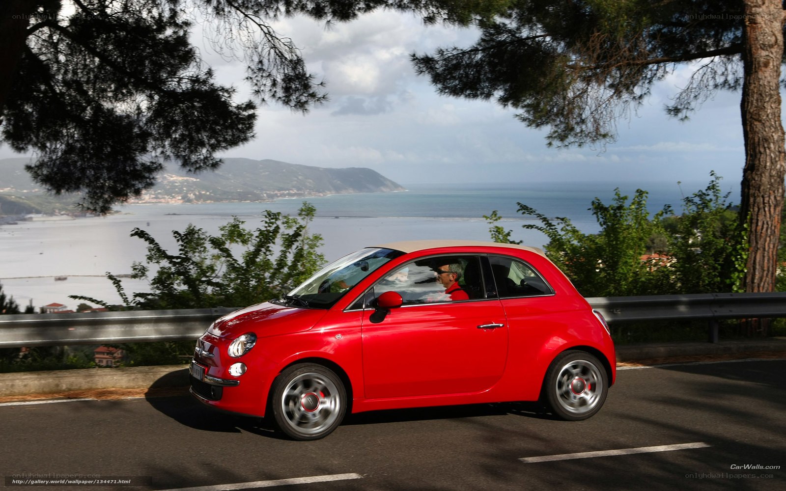 Red car on coastal road