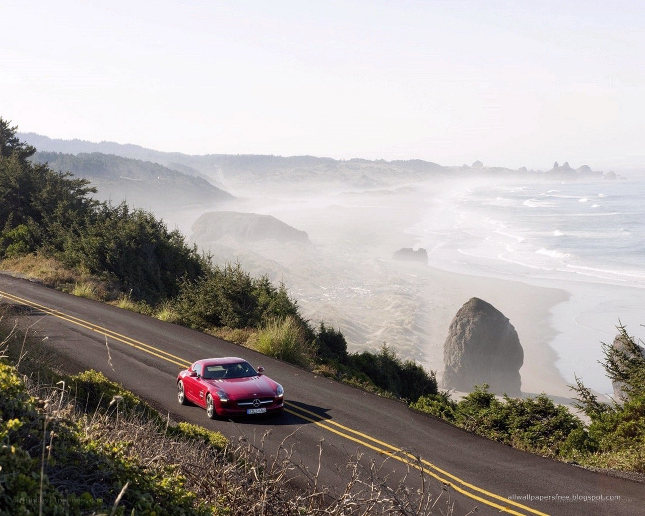 Red car on coastal road