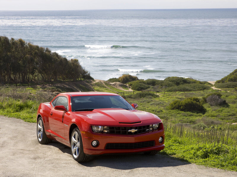 Red car on coastal road