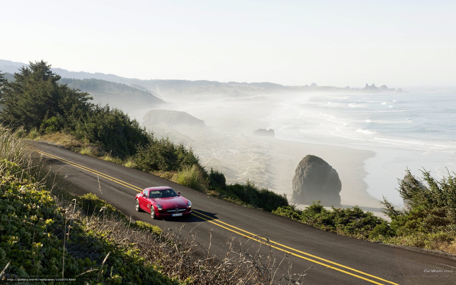 Red car on coastal road