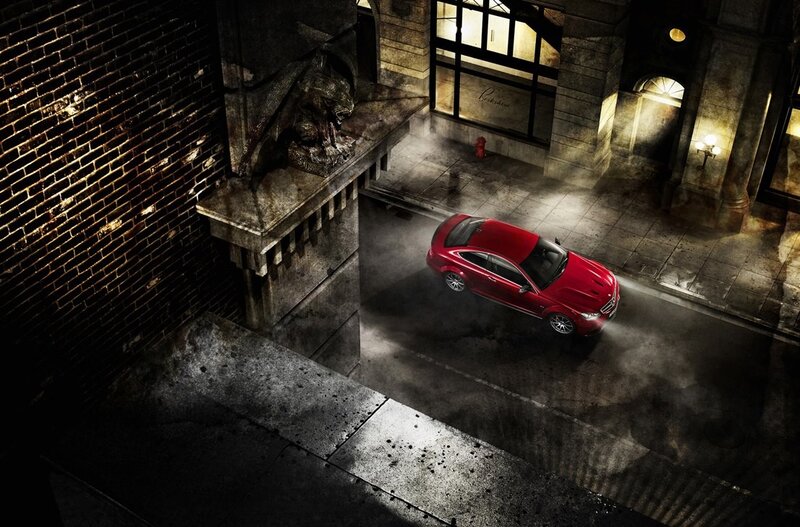 Red car on dark city street