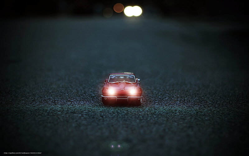 Red car on dark road