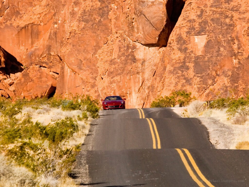 red car on desert road