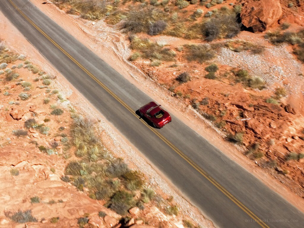 Red car on desert road