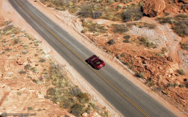 Red car on desert road