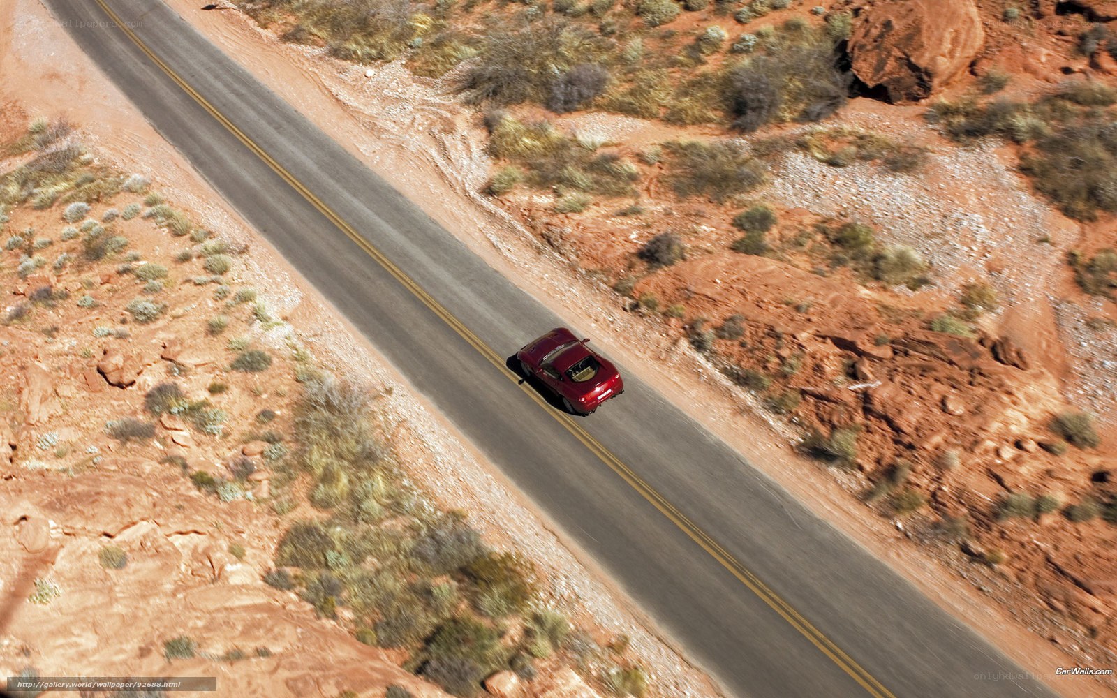 Red car on desert road