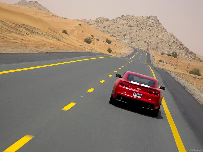 Red car on desert road