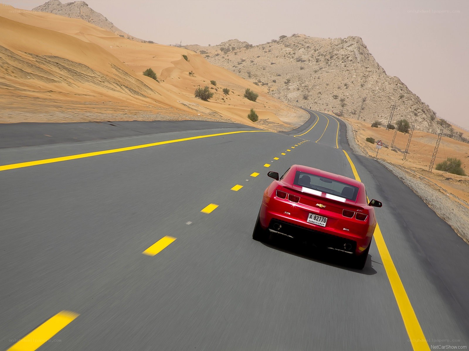 Red car on desert road