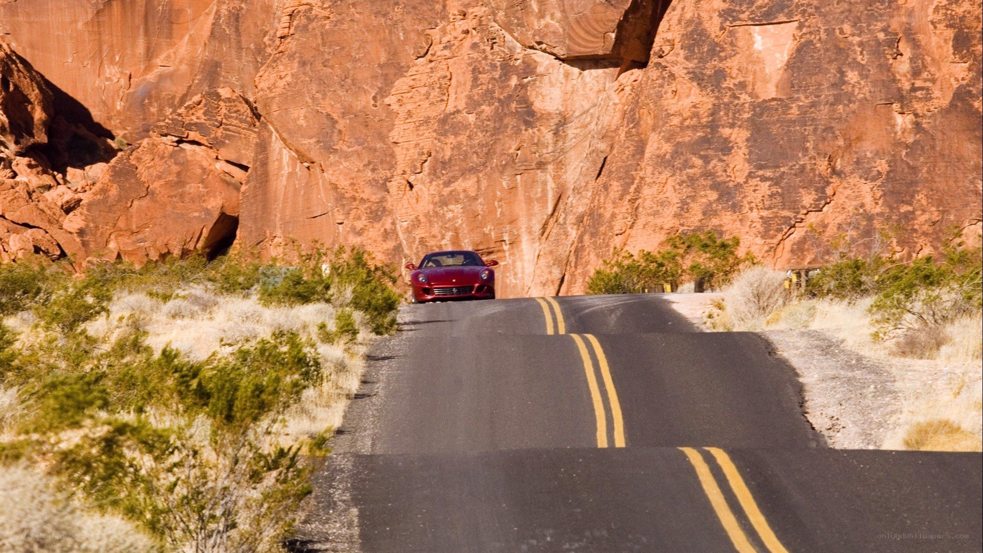 red car on desert road