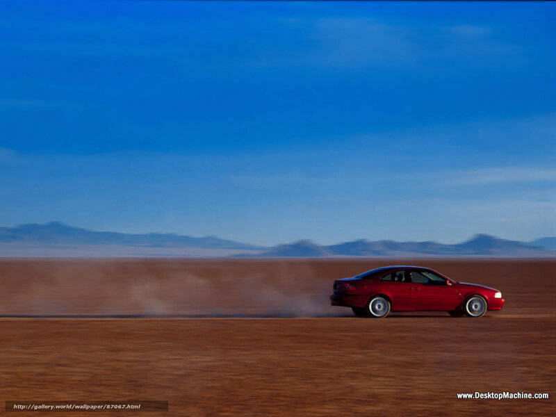 Red car on desert road
