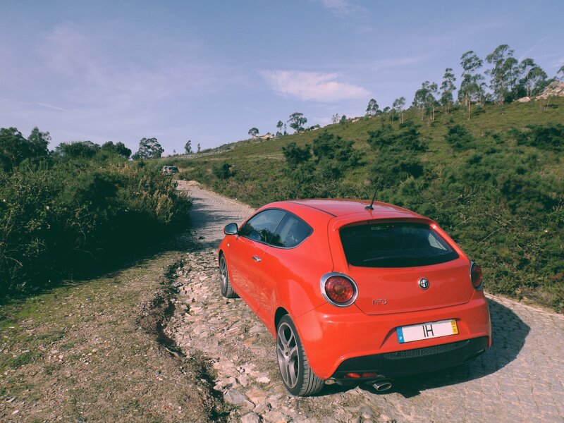 Red Car on Dirt Road — Serene