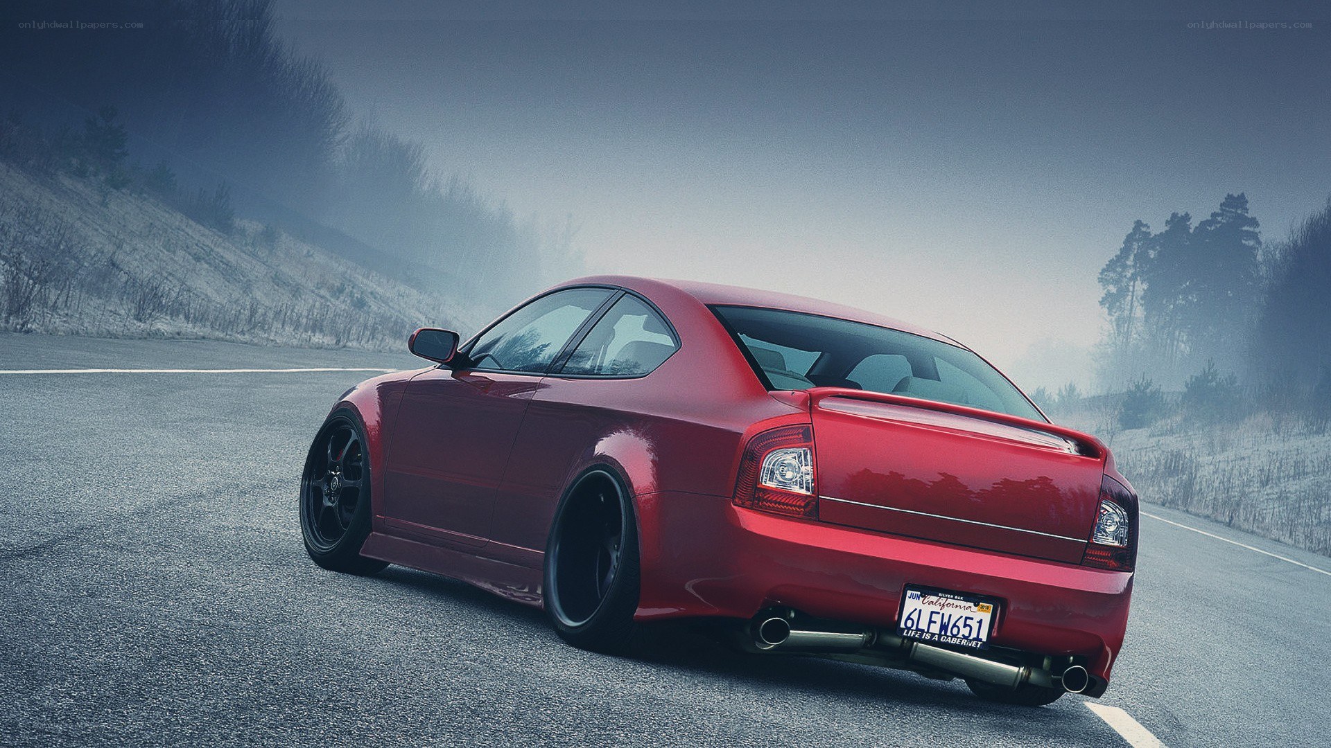 red car on foggy road