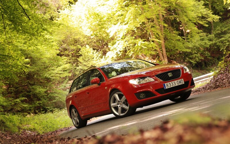 Red car on forest road
