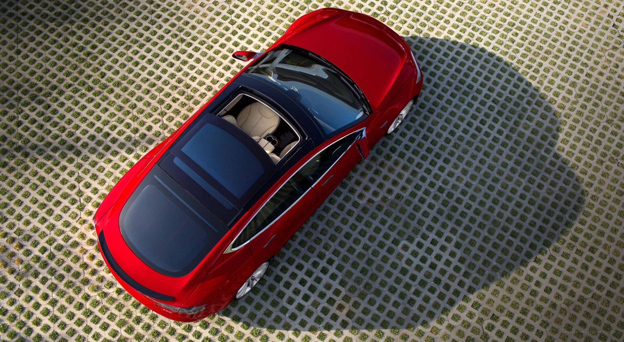 Red car on green pavement