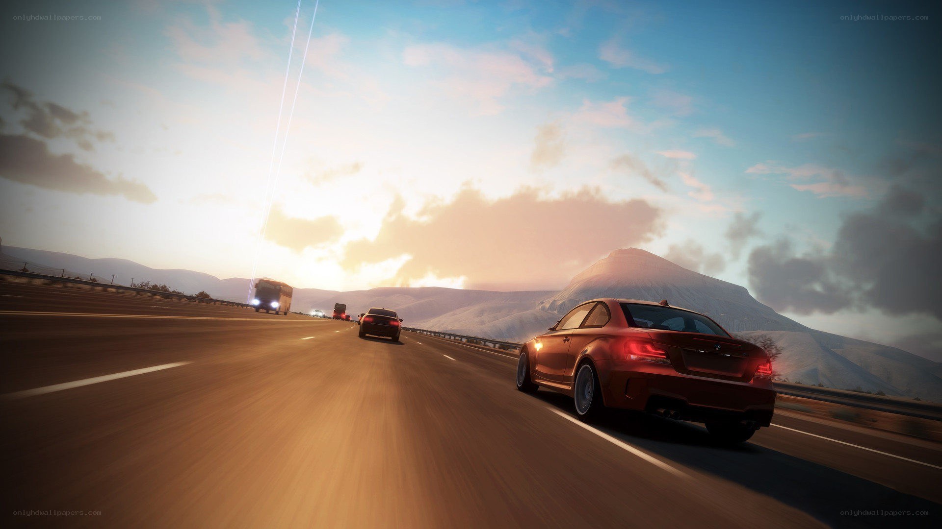 Red car on highway at sunset
