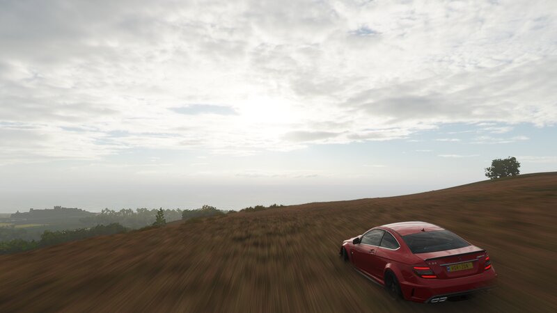 Red Car on Hillside