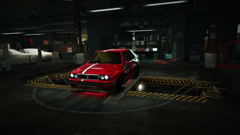 red car on lift in garage