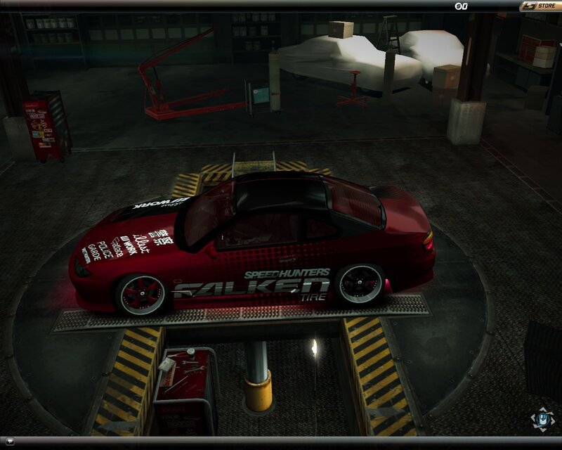 red car on lift in garage