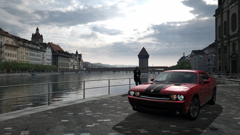 Red car on riverside promenade