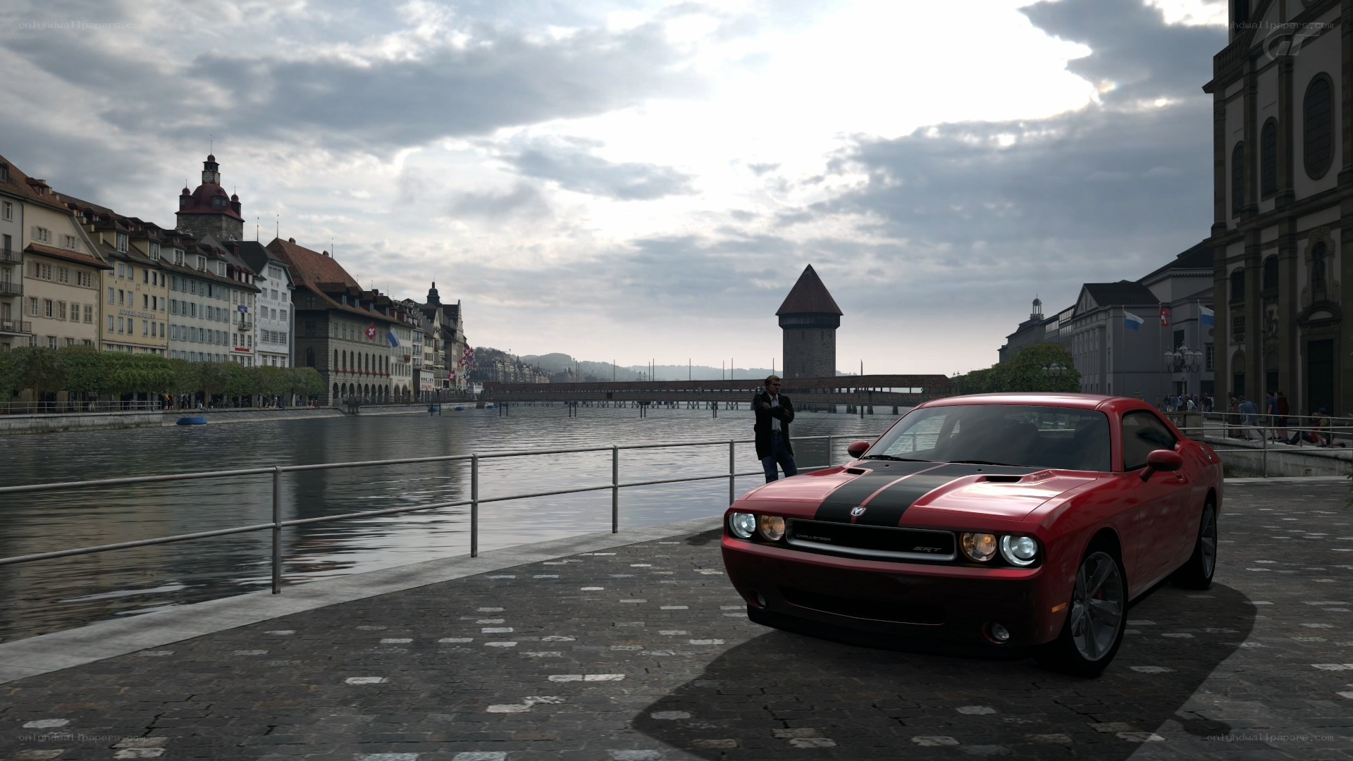 Red car on riverside promenade